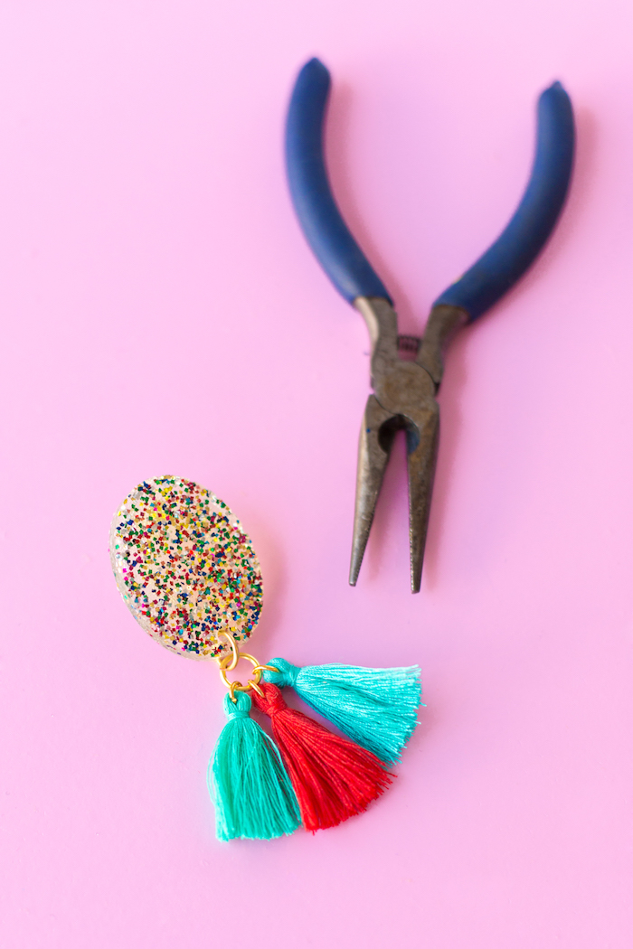 blue pliers, colourful tassel earrings, colourful glitter, birthday gift ideas, pink background