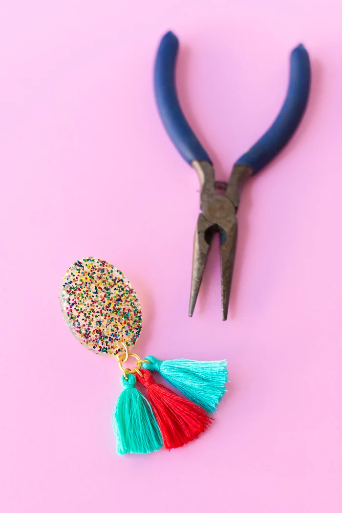 blue pliers, colourful tassel earrings, colourful glitter, birthday gift ideas, pink background