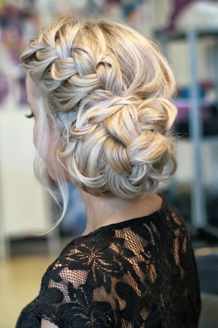 blonde hair, with highlights, in a low updo, braided bun, half up half down prom hair