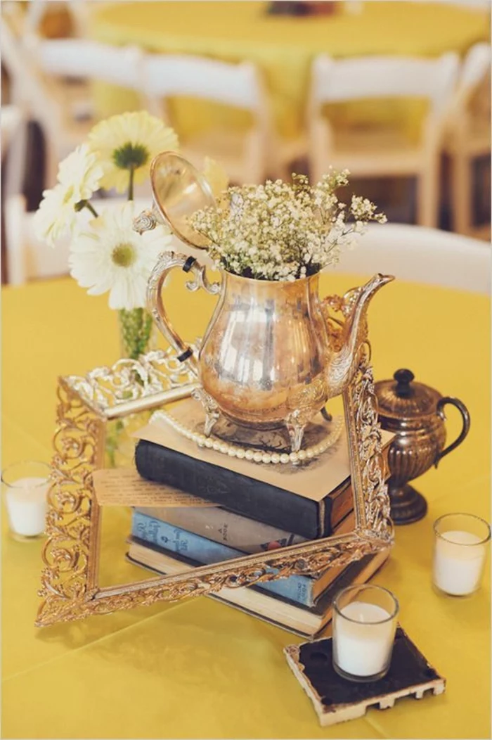 vintage teapot, spring flower arrangements, on top of books, golden frame, glass candle holders