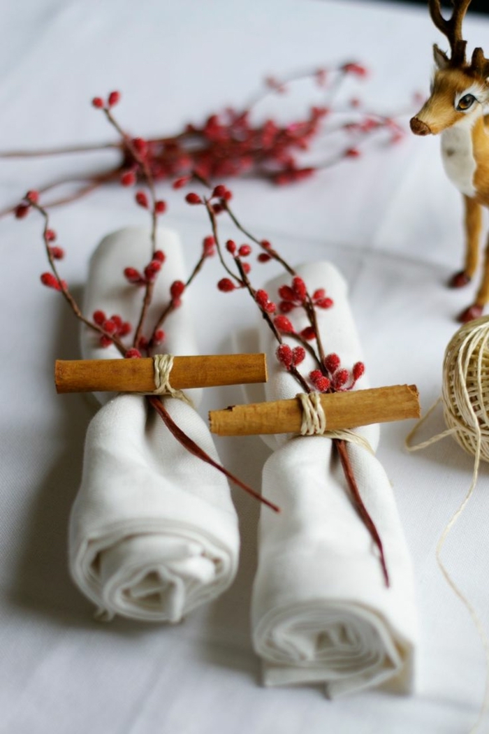 folded white cotton napkins, tied with paper and a tree branch, spring flower arrangements