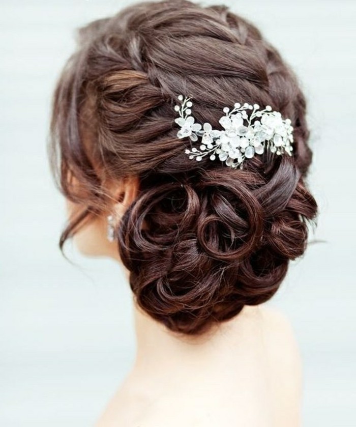 brown hair, in a low updo, floral hair accessory, prom hairstyles half up half down