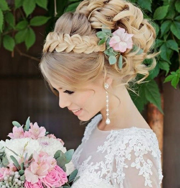 brown hair, in a high messy updo, braid across, prom hairstyles half up half down, flower hair accessory