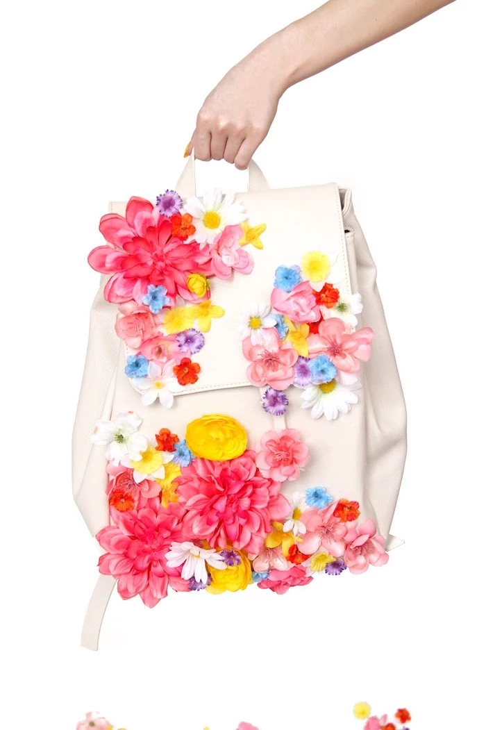colourful faux flowers, glued to a white leather backpack, homemade christmas gifts