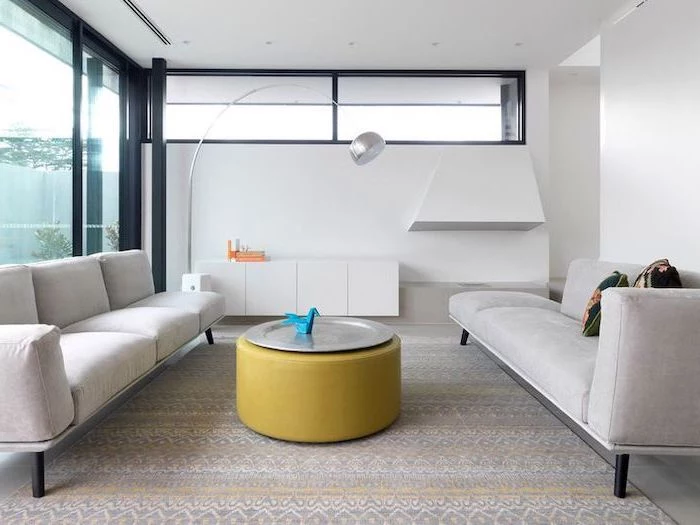 white sofas, yellow ottoman, metal tray, printed carpet, how to arrange furniture, white cabinets