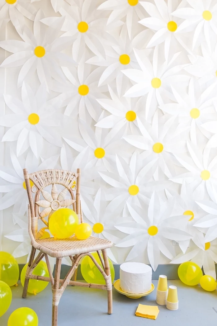 wall full of daisies, wooden chair, yellow balloons around, bedroom wall decor, yellow cake stand