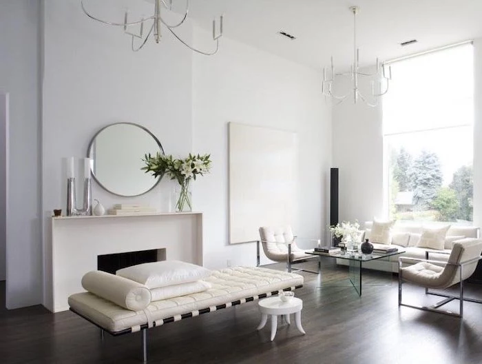 living room dining room combo, white sofa, white armchairs, wooden floor, white walls, glass coffee table