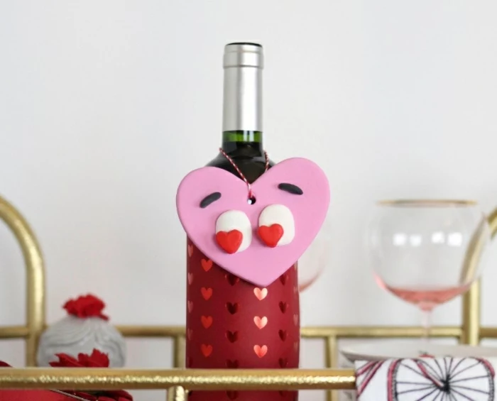 diy gifts for friends, wine bottle, red sleeve with hearts, large pink heart, with heart shaped eyes