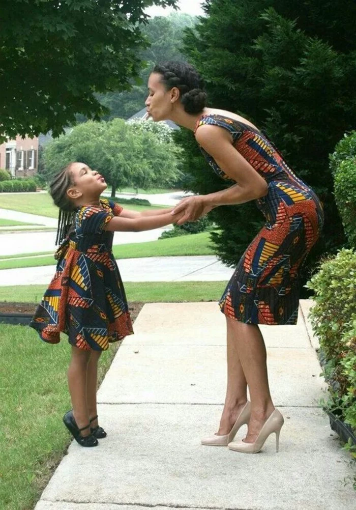 african print maxi dresses, woman and a girl, holding hands and kissing, short dresses, braided hair