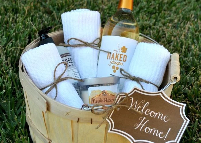 wooden basket, wine and towels inside, good housewarming gifts, diy gift basket