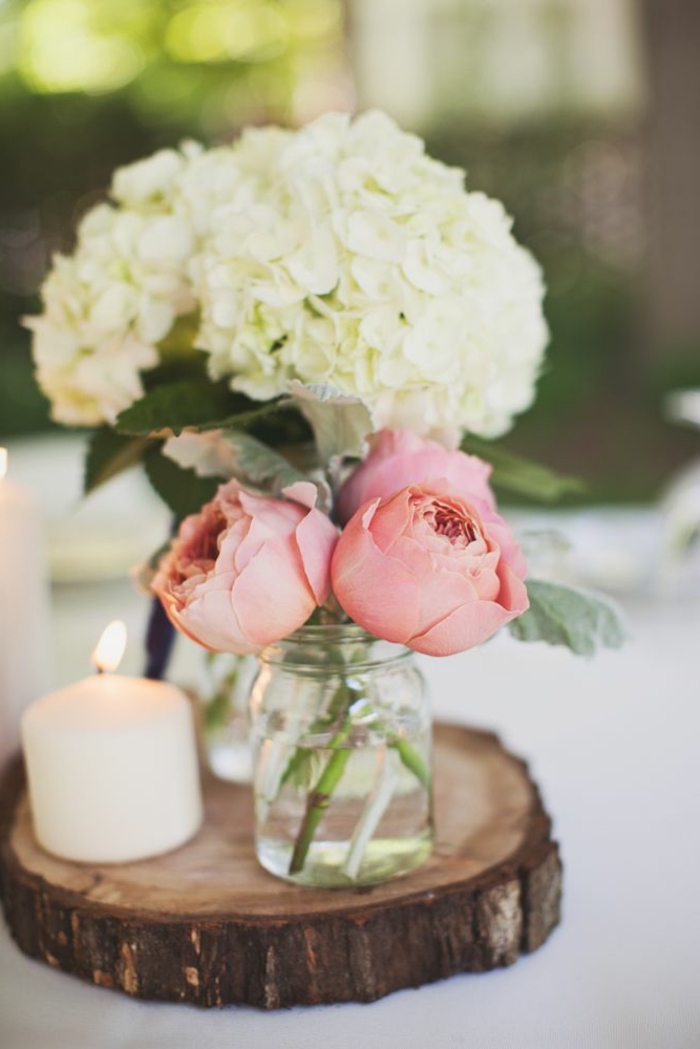 wooden board, two glass vases on top, flower bouquets inside, spring flower arrangements
