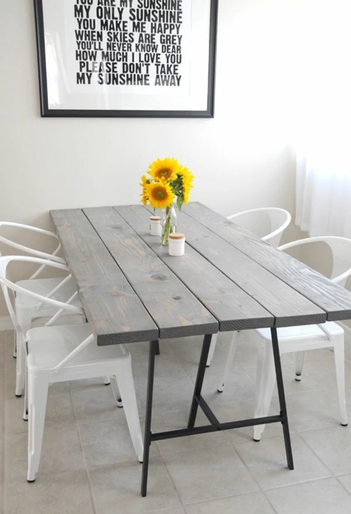 wooden grey table, metal white chairs, table arrangements, small sunflower bouquet, framed inspirational quote