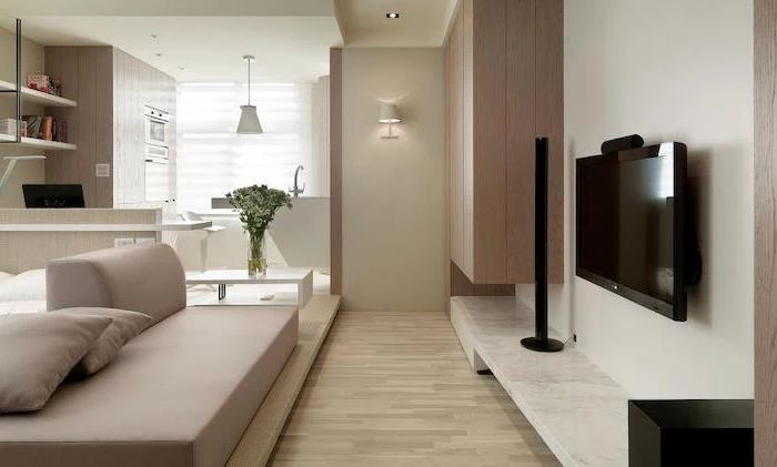 beige sofa, wooden floor, living room dining room combo, wooden cabinets, marble countertop