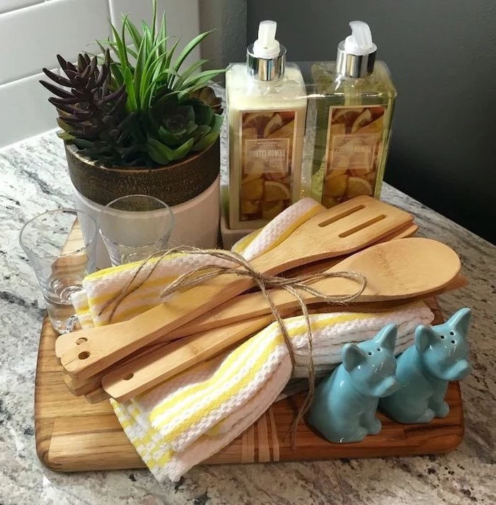 wooden cutting board, diy gift basket, towels and spatulas, what is a good housewarming gift, potted succulents