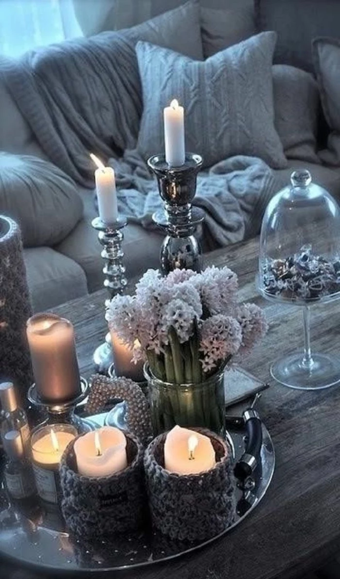 metal tray, candles in candle holders on top, table arrangements, round glass vase, bouquet of hyacinth flowers