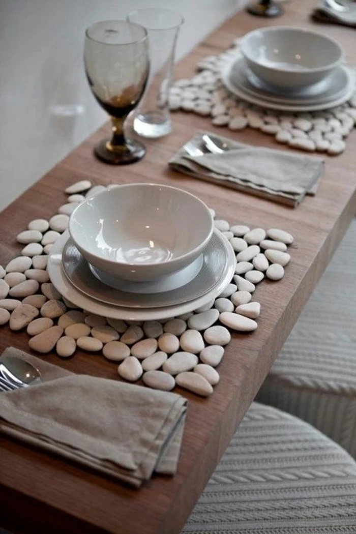 wooden table, white and grey plates and bowls, table arrangements, grey cotton napkins, wine glasses