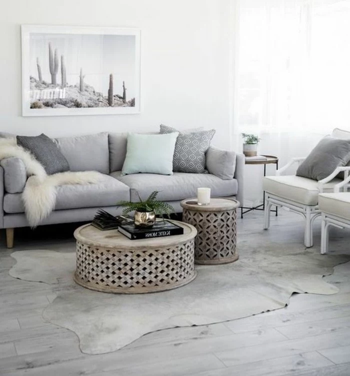 wooden round coffee table, grey sofa, light blue throw pillow, white armchairs, popular living room colors