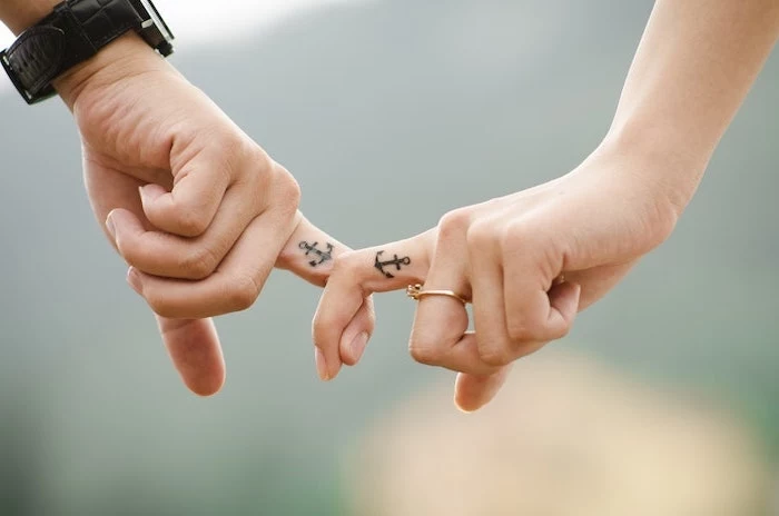 anchor tattoos, inside the finger, matching couple tattoos, black leather watch, gold engagement ring