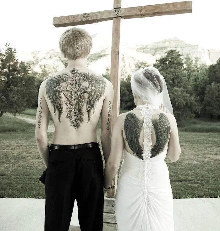 relationship tattoos, woman wearing a wedding dress, angel wings, back tattoo, wooden cross