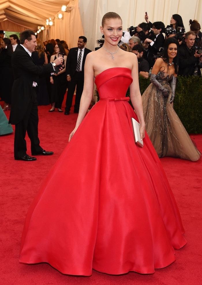 arizona muse, wearing a long red dress, strapless dress, met gala 2017 theme, crystal necklace