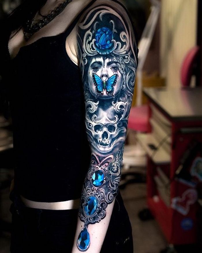 arm tattoos for women, woman and skull, blue crystals, blue butterfly, arm sleeve tattoo