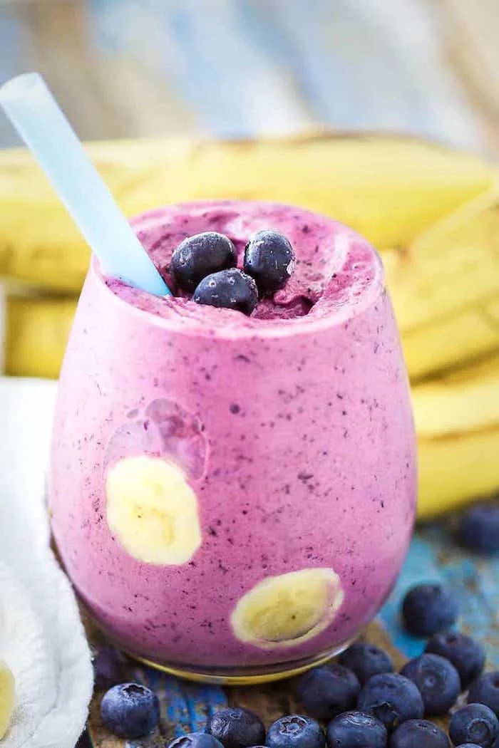 blackberries and bananas, small glass, blue straw, banana smoothie recipe
