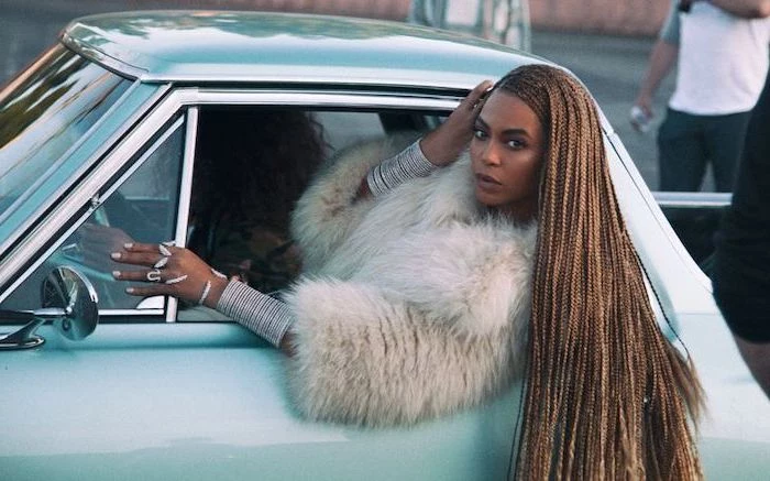 beyonce's formation video, showing out of a car, ghana braids, on long light brown hair, blue vintage car