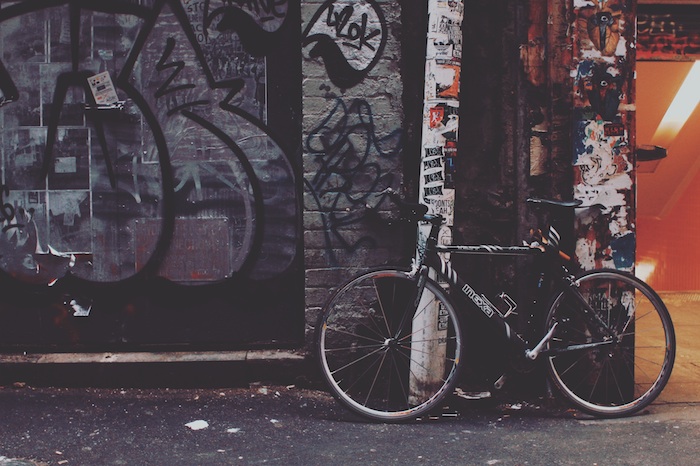 city sidewalk, bicycle leaning on a wall, covered in graffiti, wallpaper tumblr