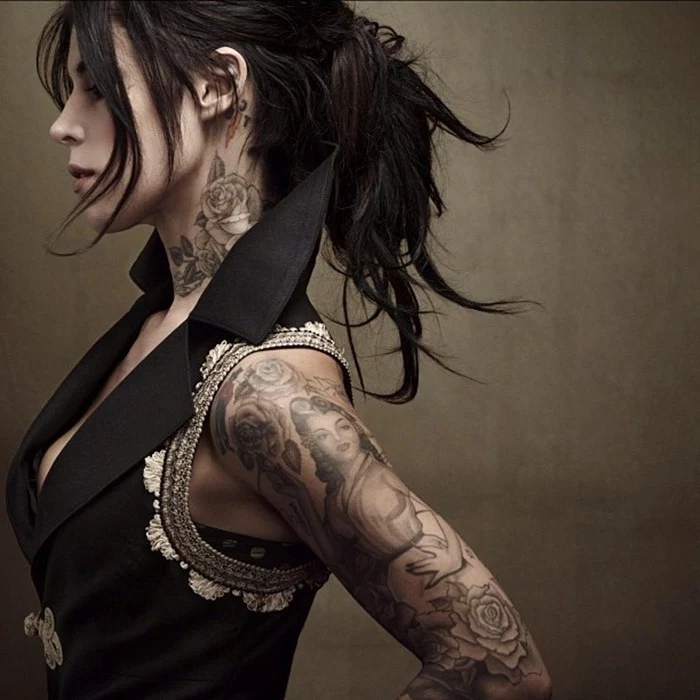 black jacket, black hair, cute tattoos for girls, rose neck tattoo, large arm sleeve tattoo