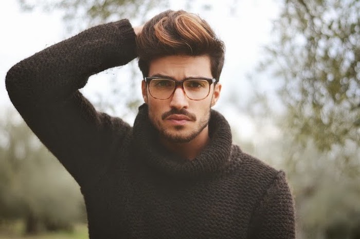 man wearing sunglasses, a black polo sweater, hairstyles for men, brown hair