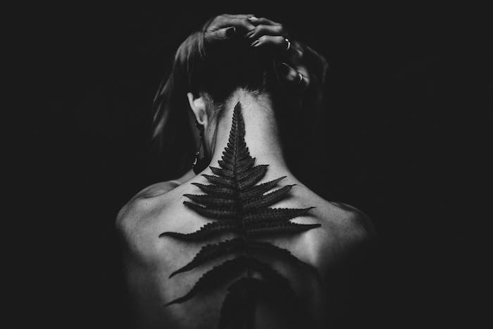 woman holding her hair, 3d back tattoo, love quotes tumblr, black and white photo
