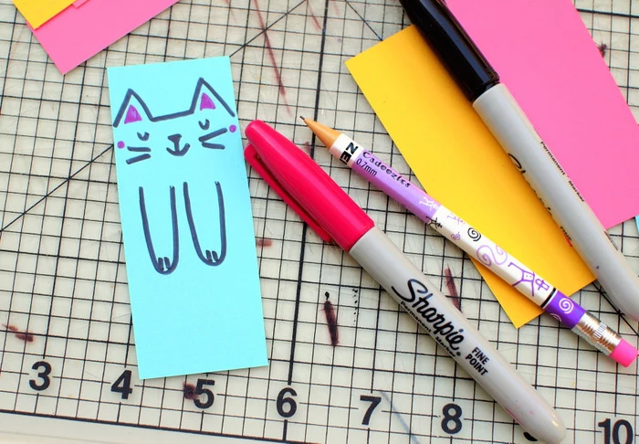 colourful paper, cat face and paws drawn on blue paper, preschool activities, black and pink sharpies