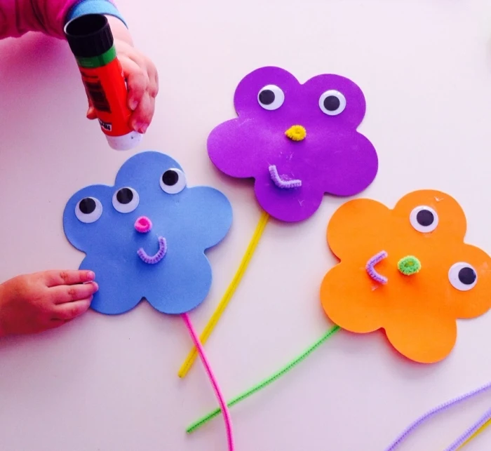 colourful flowers, made of felt, with googly eyes, school themes, blue purple and orange