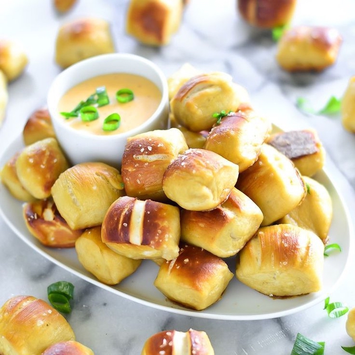 bread bites, beer sauce, inside a white bowl, chopped onions, vegetarian appetizers