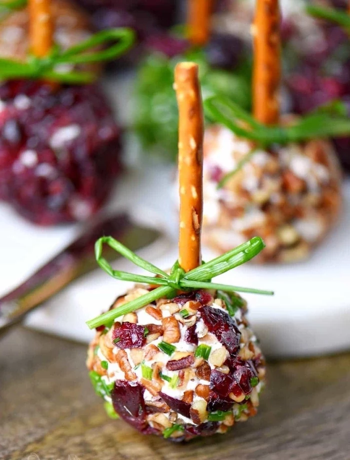 dairy free appetizers, salty cake pops, cheese bites, with nuts and cranberries, on a wooden table