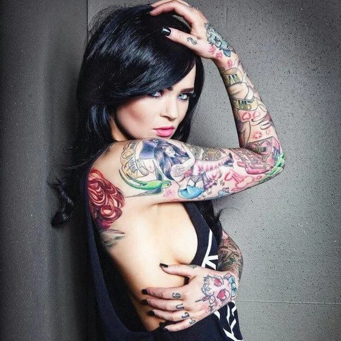 back tattoos for women, colourful arm sleeve tattoo, black top, black hair, grey background