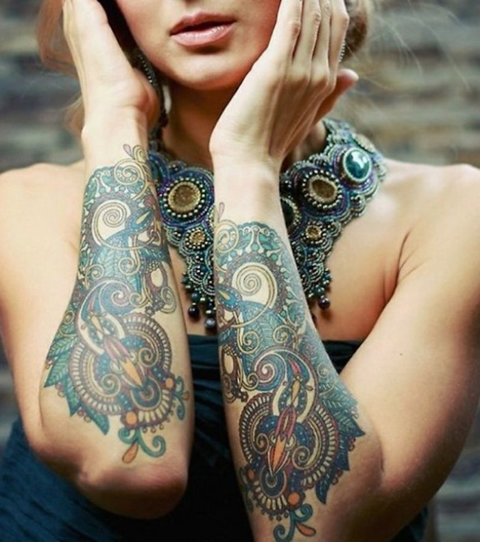 tattoo ideas for women, colourful arm tattoos, large necklace, blonde hair