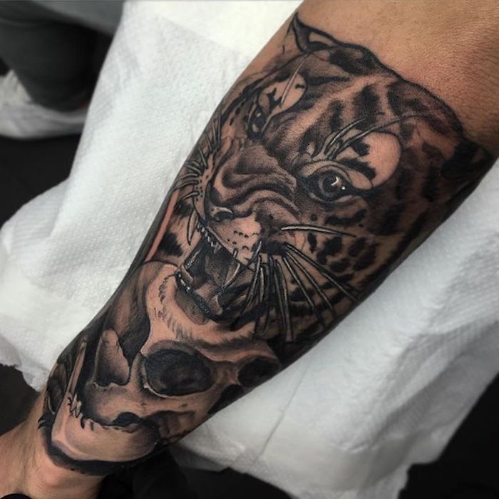 roaring tiger, skull underneath, arm tattoos for women, white paper
