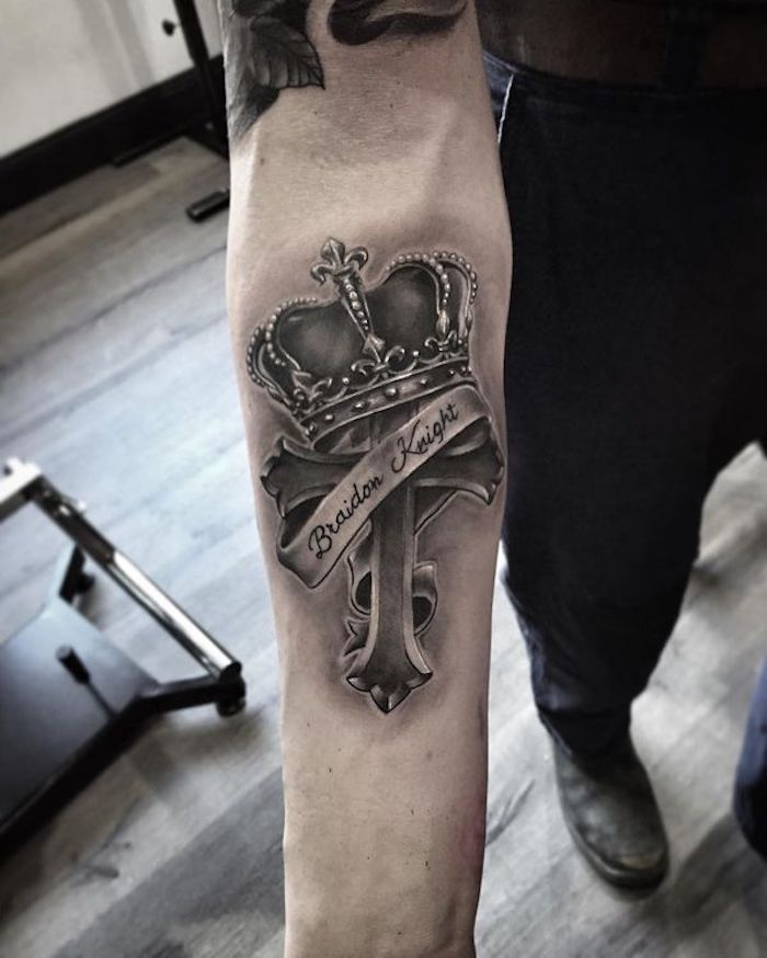 crown on top of a cross, forearm tattoo, tattoo designs for men, wooden floor