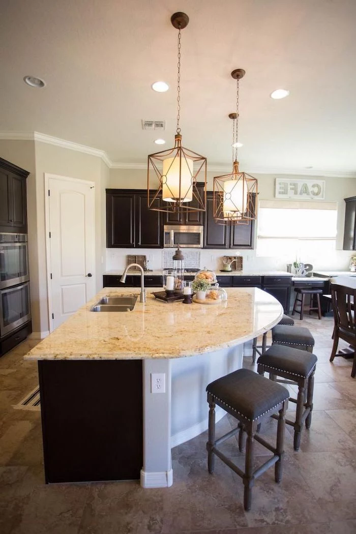 curved kitchen island, black wooden bar stools, island countertop, tiled floor, wooden cabinets