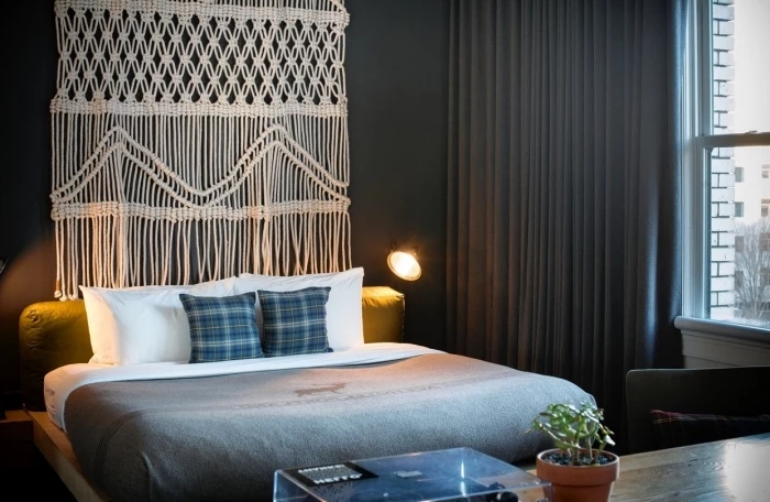 black wall, grey curtains, macrame tutorial, potted plant, white and grey bed linen