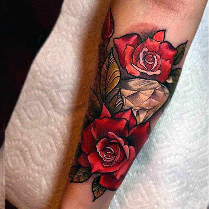 white paper, large diamond, surrounded by red roses, chest tattoos for women, forearm tattoo