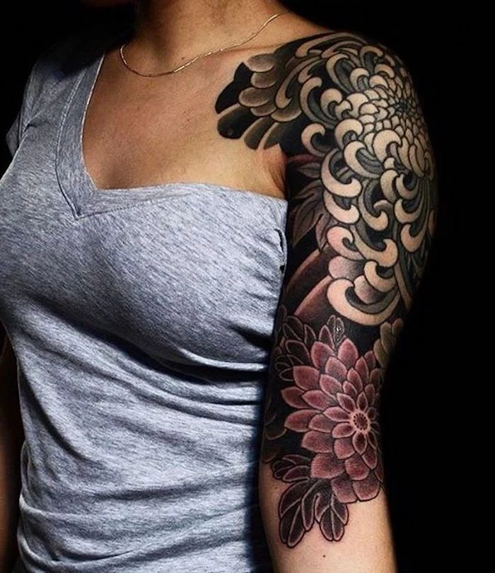 grey top, side tattoos for girls, floral shoulder sleeve tattoo, black backgorund