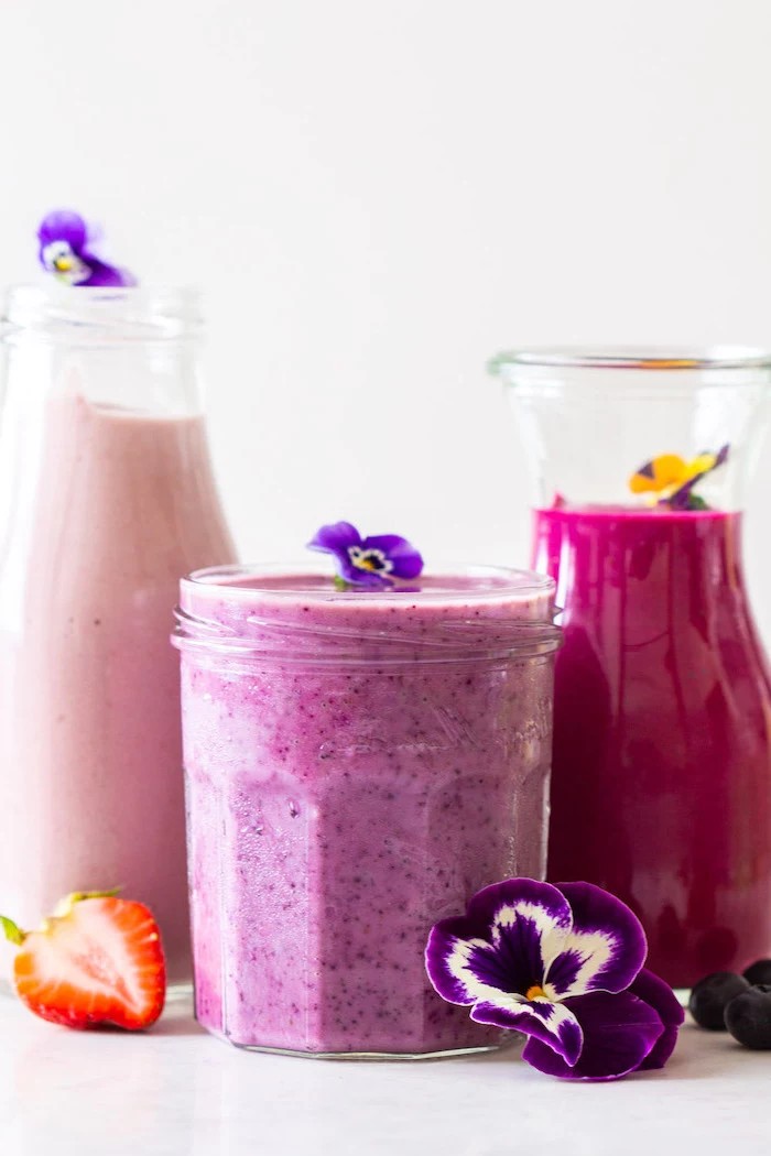 tall bottles and jars, purple flowers, how to make a strawberry smoothie