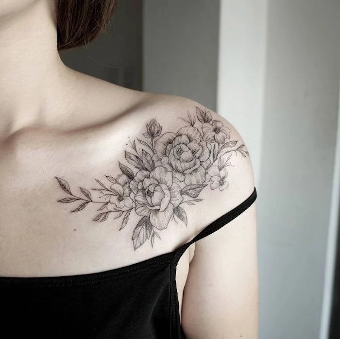 black top, small meaningful tattoos, flowers shoulder tattoo, brown hair