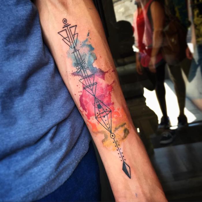 geometrical arrow, watercolour forearm tattoo, arm tattoos for girls, blue shirt