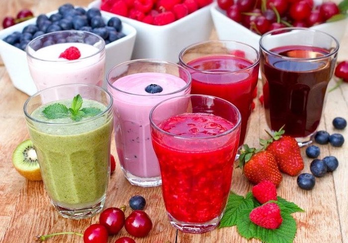 tall glasses, filled with smoothies, made with different ingredients, strawberry banana smoothie, different fruits