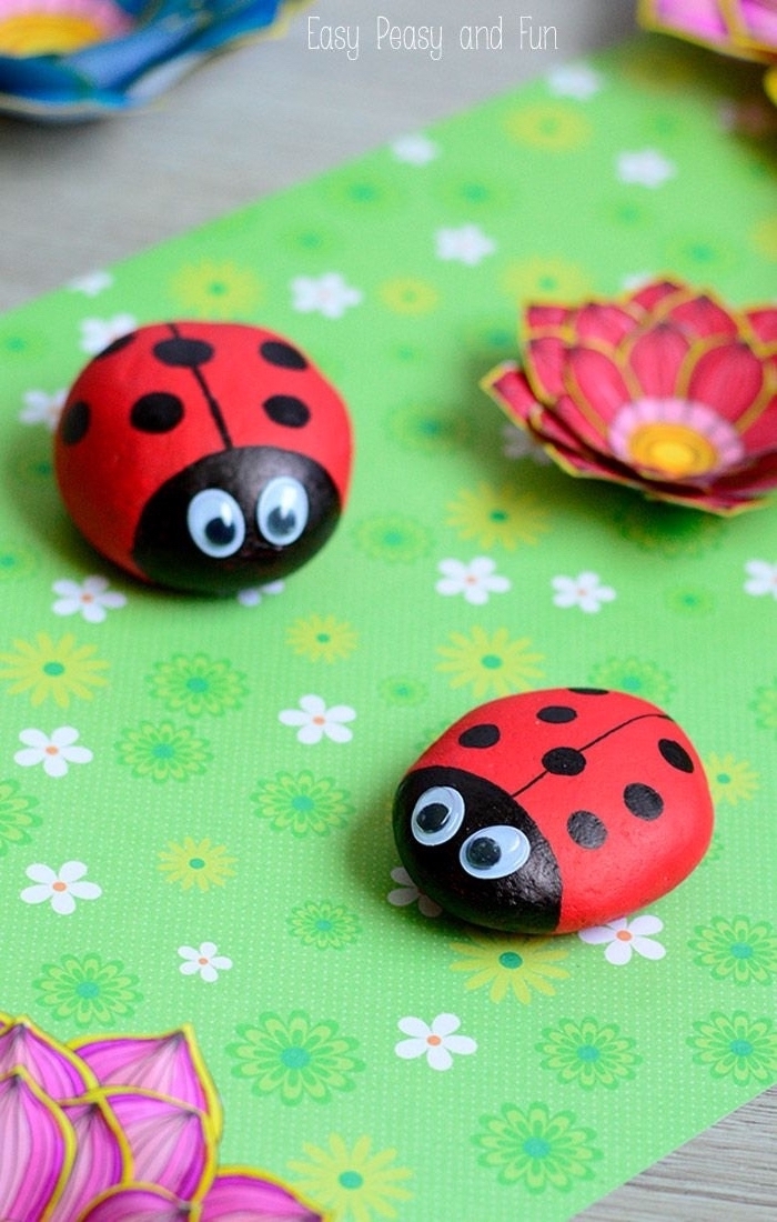 preschool games for kids, green paper, ladybugs made of rocks, with googly eyes