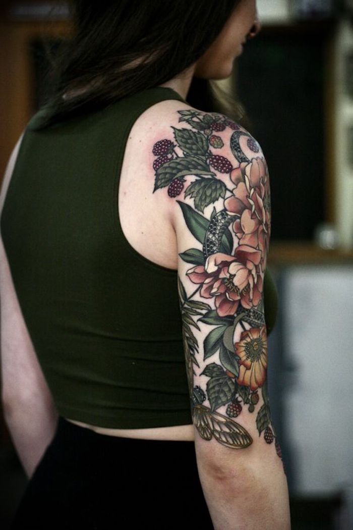 chest tattoos for females, colourful flowers, shoulder tattoo, green top, black pants