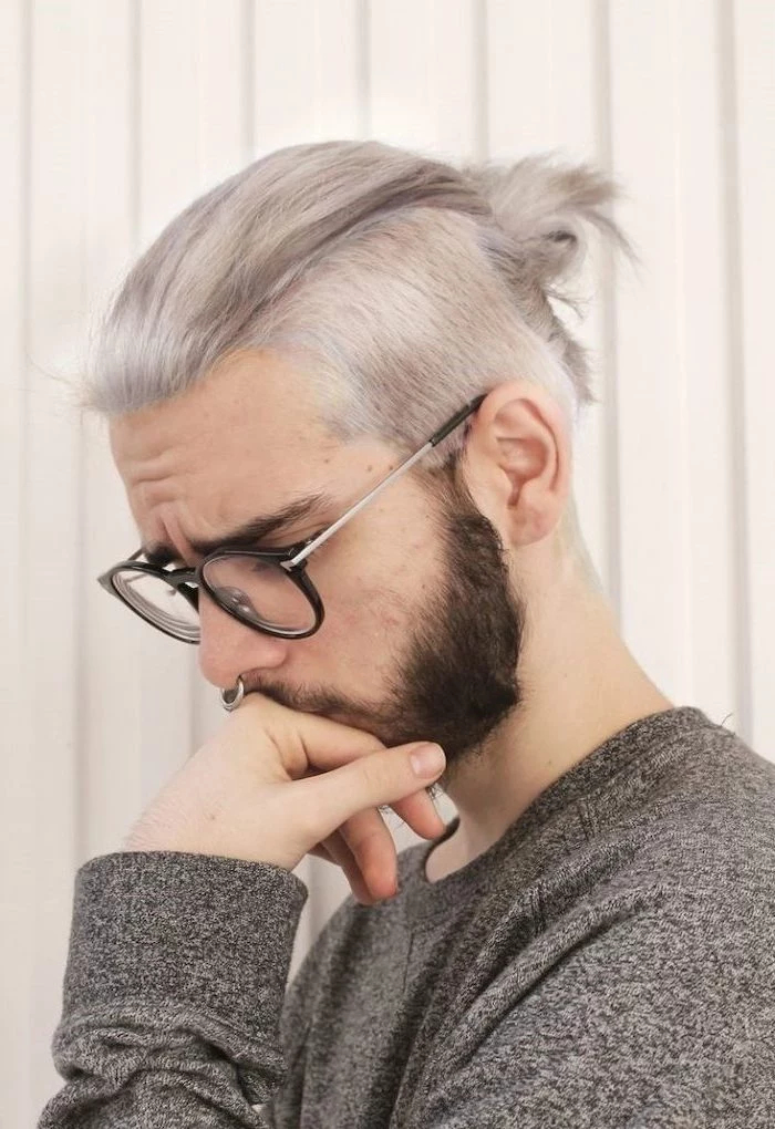 grey hair, in a bun, best hairstyle for men, man wearing glasses, grey blouse